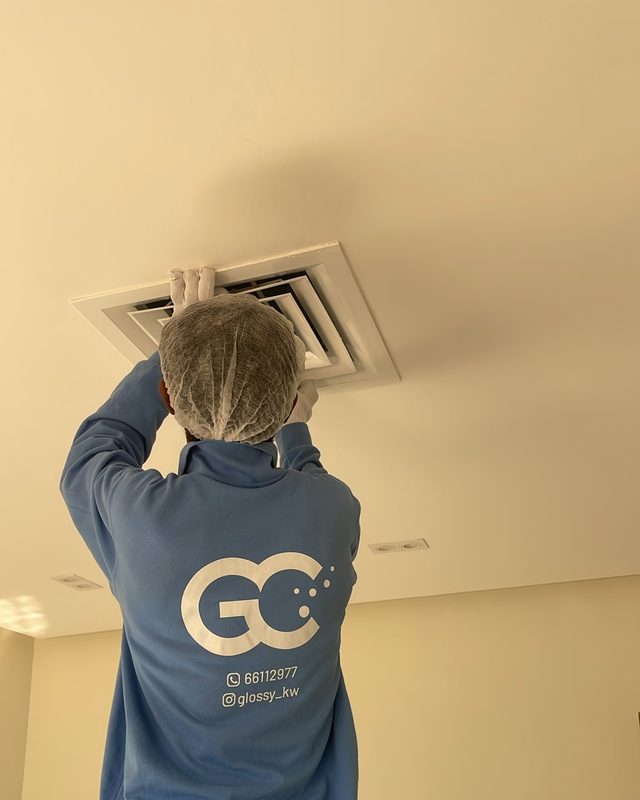 Glossy technician cleaning an A/C vent